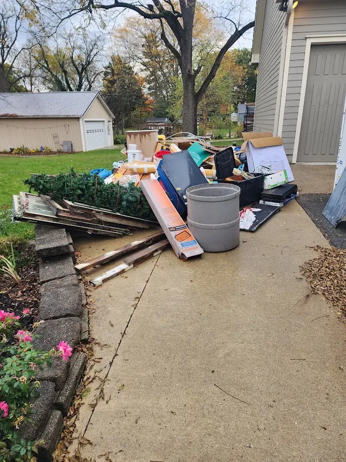 Dumpster being loaded with debris for 12 Yard Dumpster Rental in Pittston